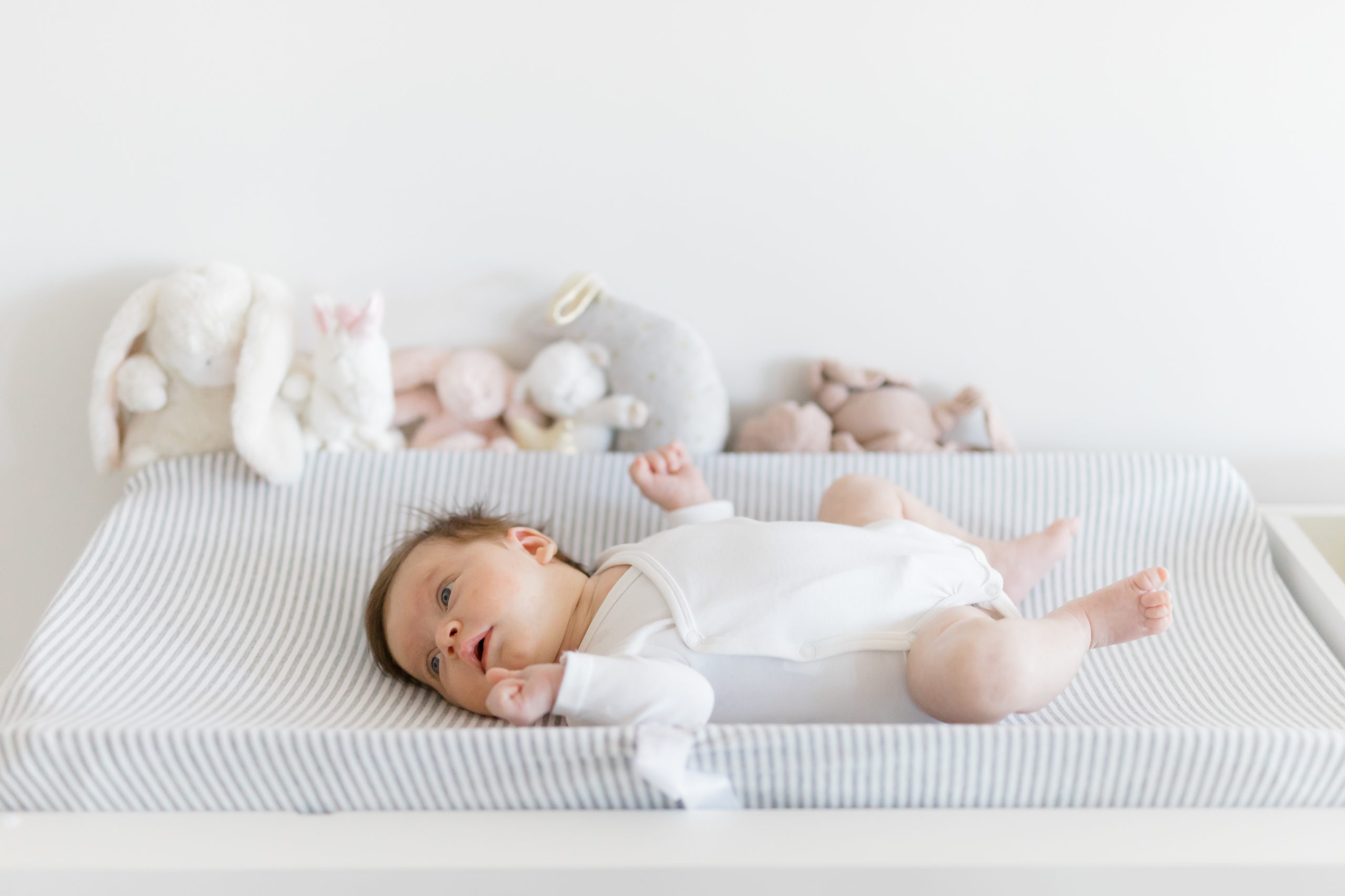 A baby on her changing table at an in home newborn photography session in NYC shot by Jacqueline Clair Photography