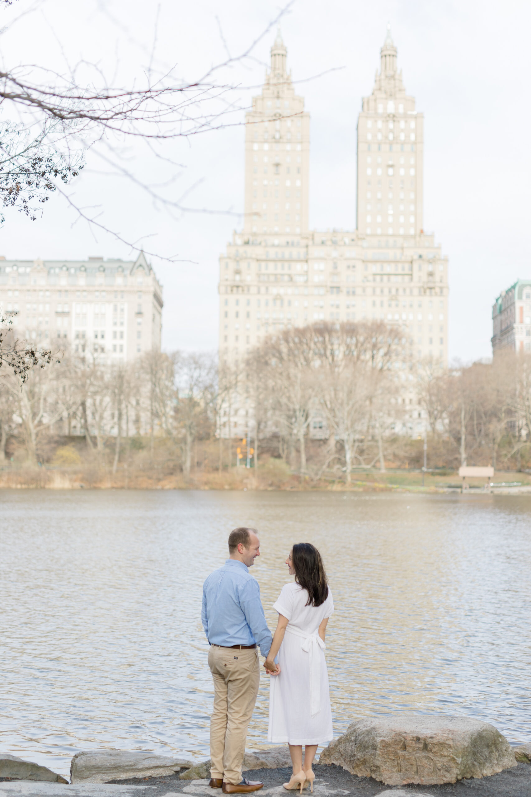 An expecting couple in front of the Lake in Central Park during a New York City maternity photography session with Jacqueline Clair Photography