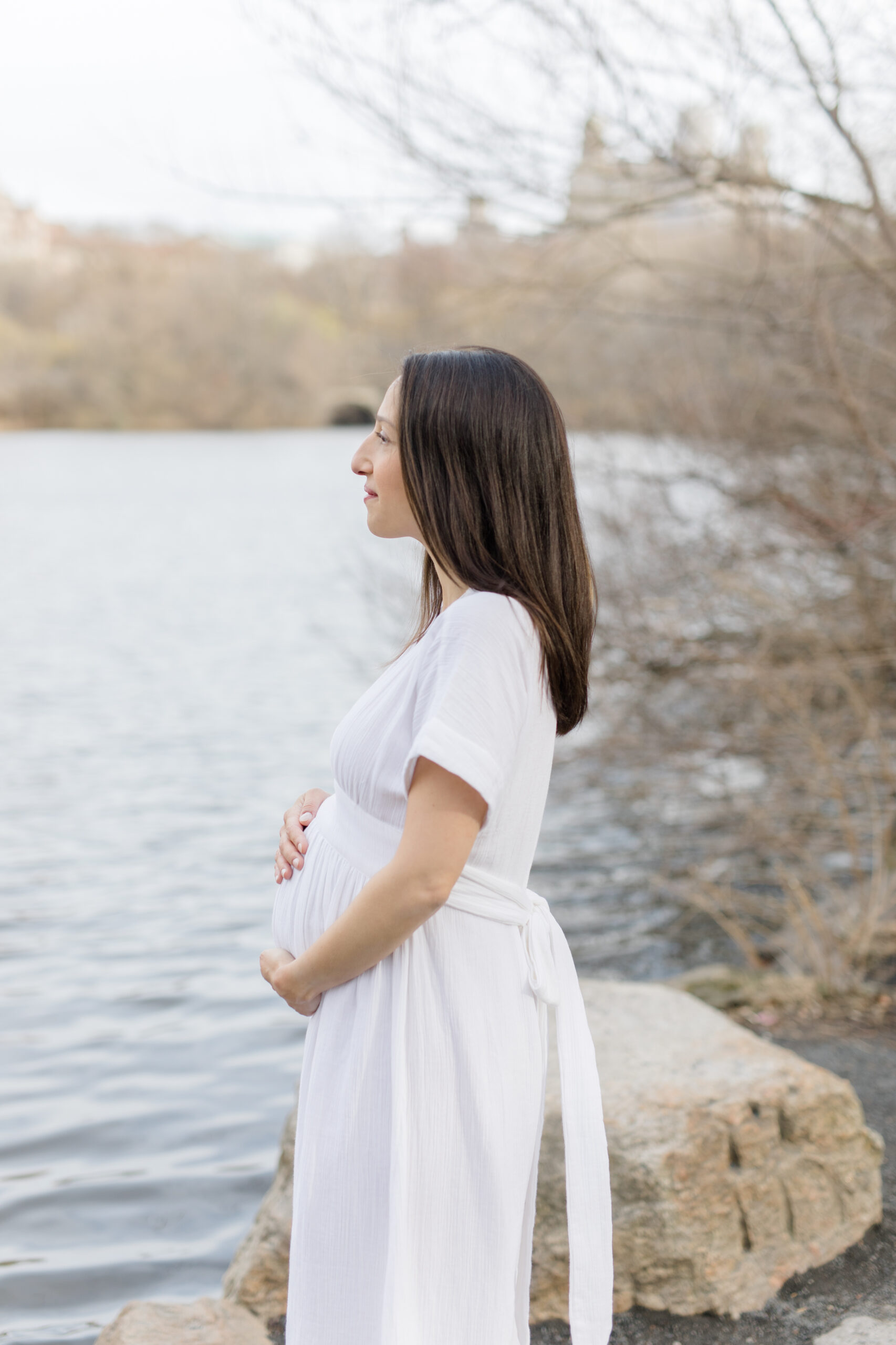 A pregnant woman in Central Park during a New York City maternity photography session with Jacqueline Clair Photography
