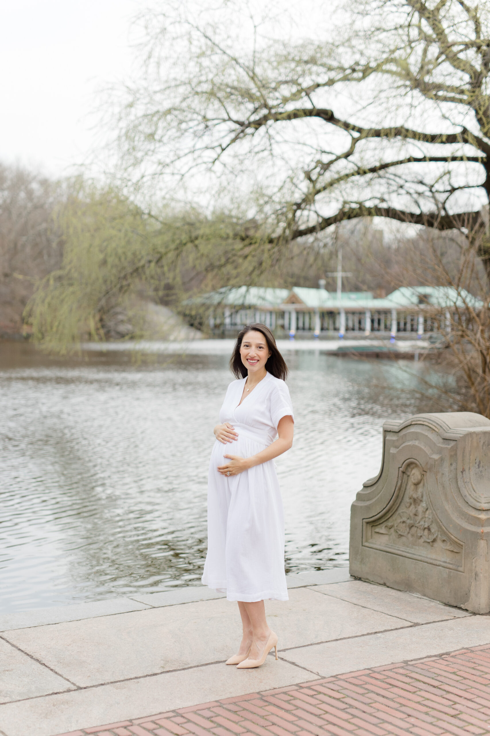 An expecting mother in Central Park during a New York City maternity photography session with Jacqueline Clair Photography