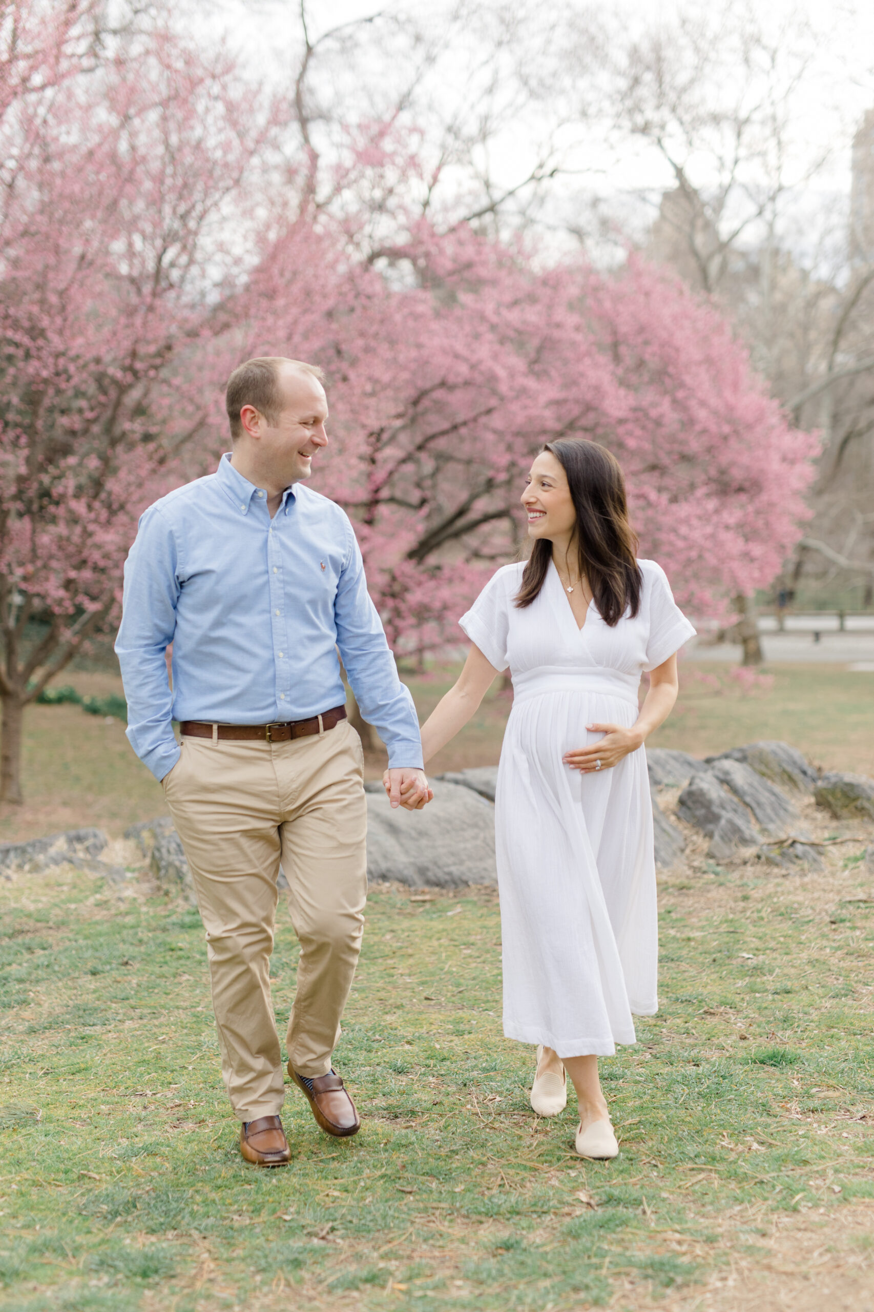 A pregnant couple walk together at a New York City maternity photography session with Jacqueline Clair Photography