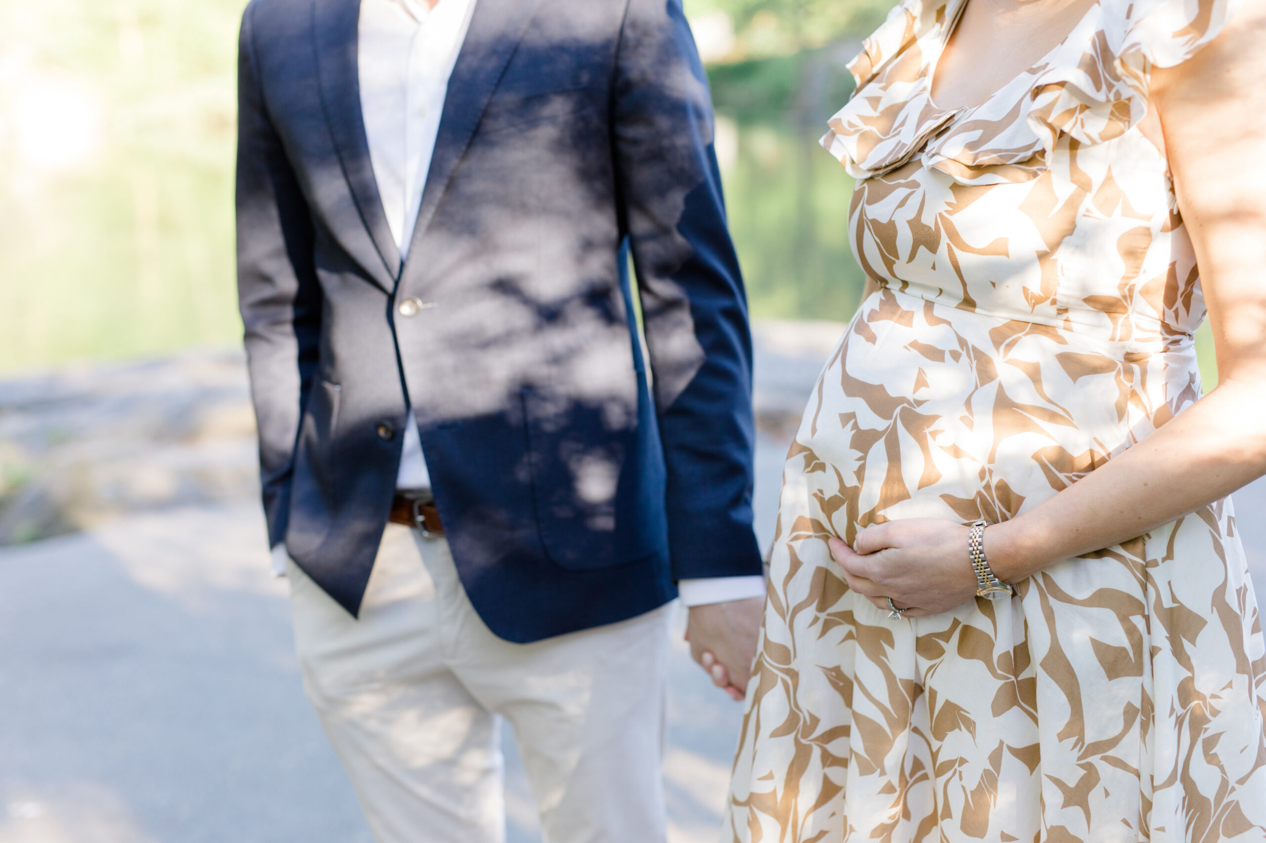A pregnant woman and her husband at a maternity photo session in Central Park shot by Jacqueline Clair Photography