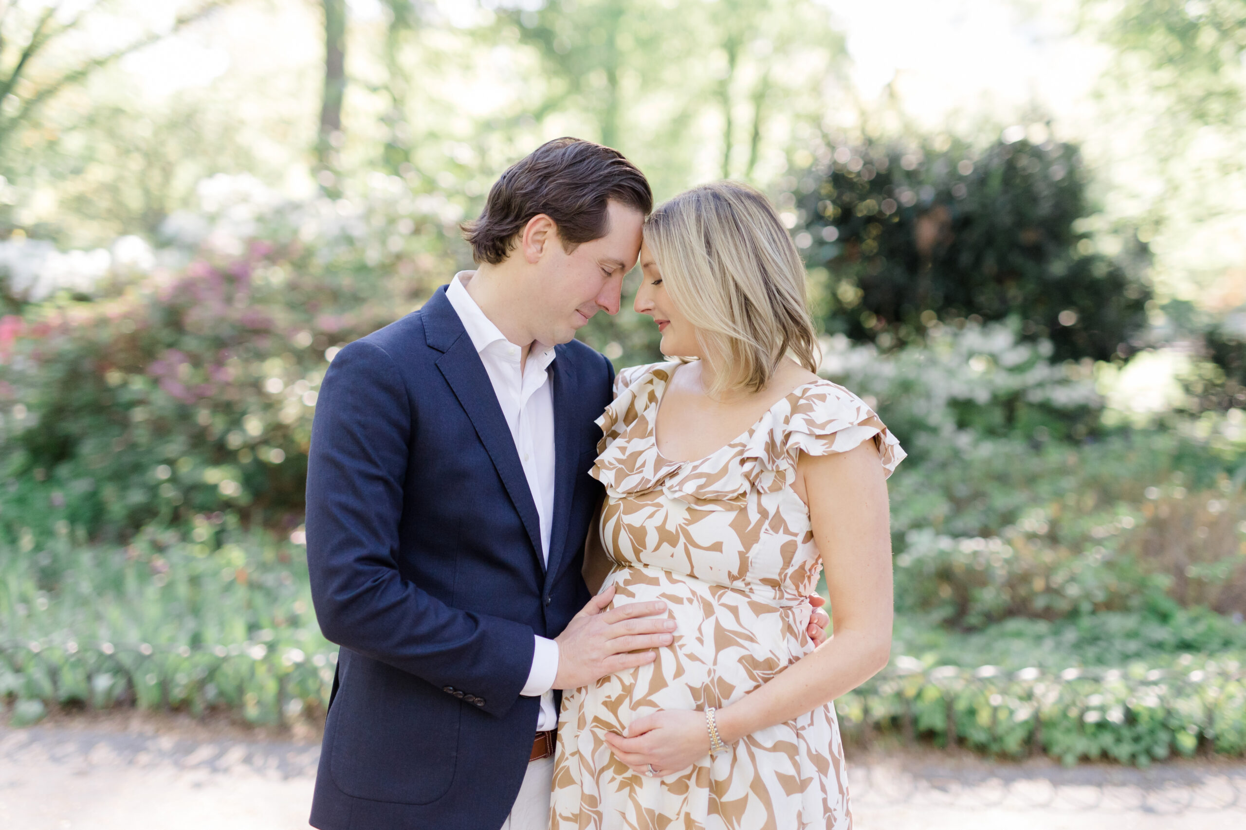 An expecting mom and her husband at a maternity photo session in Central Park shot by Jacqueline Clair Photography
