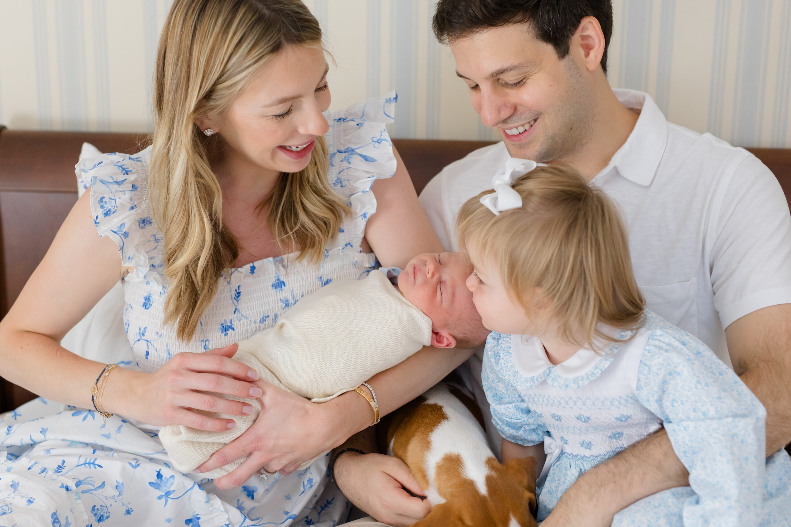 A family dressed in shades of white and blue for their lifestyle newborn session